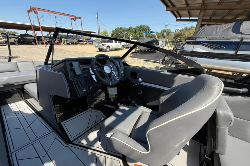 Slide: The Image of 2024 Moomba Tykon boat interior with steering wheel and seating, showcasing modern design. - 10