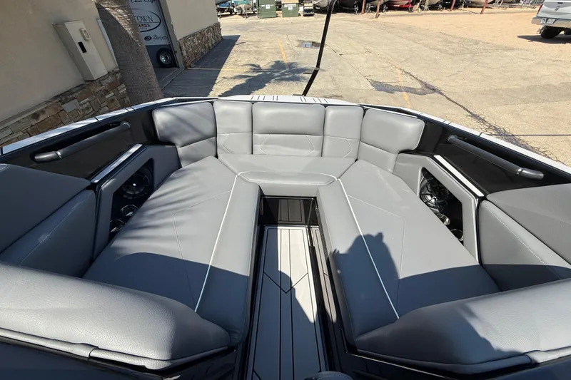 Slide: The Image of 2024 Moomba Tykon boat interior with gray seating and modern design. - 13