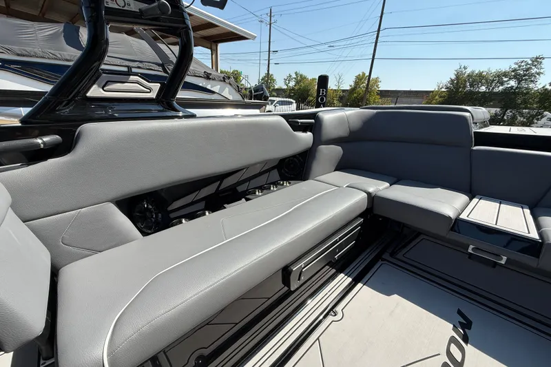 Slide: The Image of 2024 Moomba Tykon boat interior with sleek gray seating and modern design. - 15
