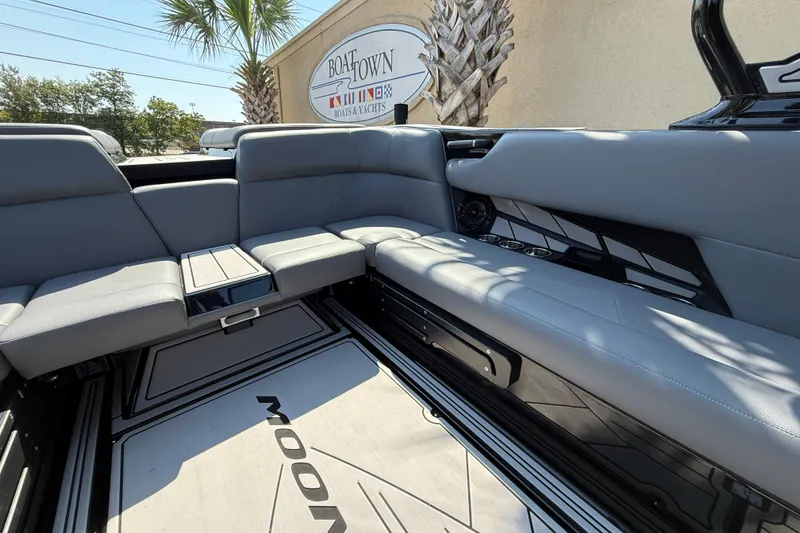 Slide: The Image of 2024 Moomba Tykon boat interior with gray seating and sleek design. - 16