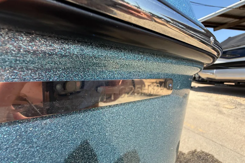 Slide: The Image of 2024 Moomba Tykon boat with metallic blue finish and identification plate. - 17