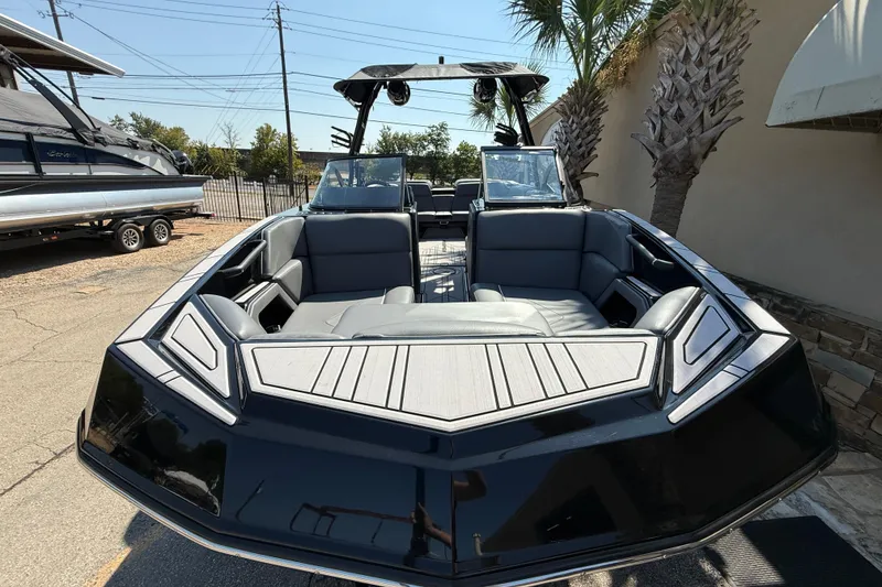 Slide: The Image of 2024 Moomba Tykon boat with sleek black design and spacious seating. - 3