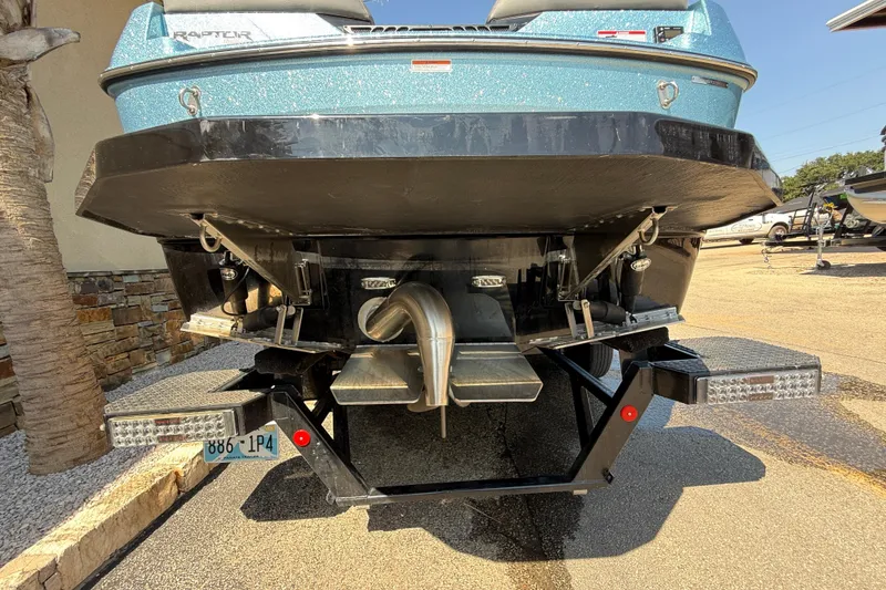 Slide: The Image of Rear view of a 2024 Moomba Tykon boat on a trailer, showcasing its hull and exhaust system. - 6