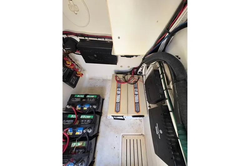 Slide: The Image of 2007 Triton 351 Express boat battery compartment with wiring and power systems. - 10