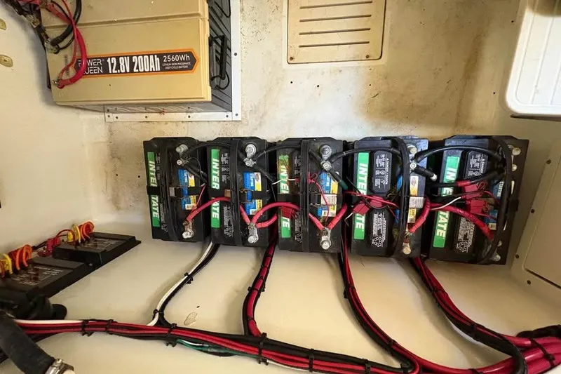 Slide: The Image of Battery setup in a 2007 Triton 351 Express boat, featuring multiple interconnected batteries. - 12