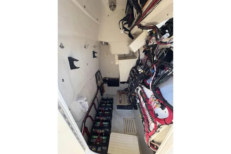 Slide: The Image of 2007 Triton 351 Express boat interior with wiring and battery setup. - 13