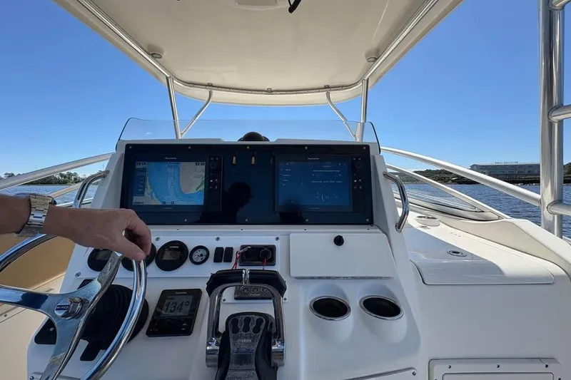 Slide: The Image of Helm of 2007 Triton 351 Express boat with navigation screens and controls. - 14