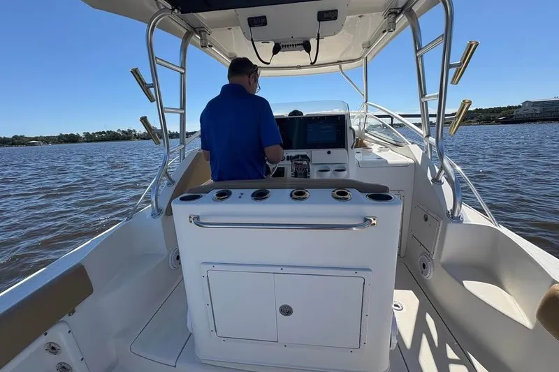 Slide: The Image of 2007 Triton 351 Express boat on water, person steering, clear day. - 15