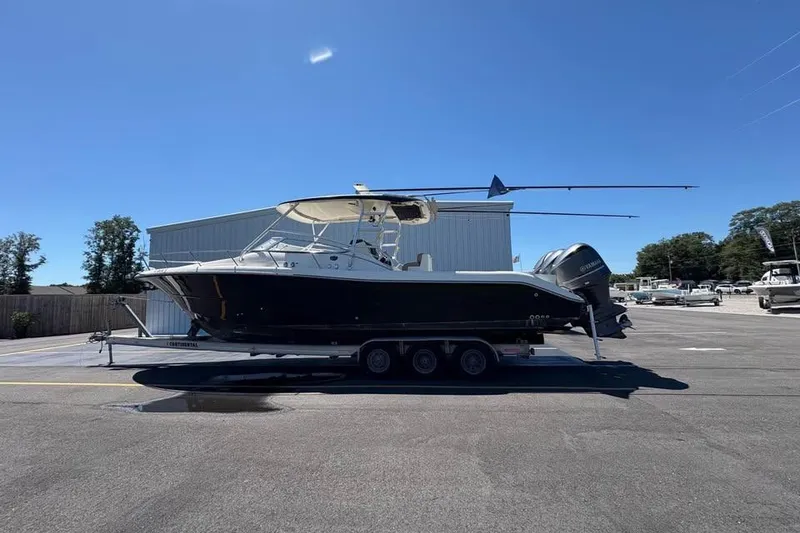 Slide: The Image of 2007 Triton 351 Express boat on trailer under clear blue sky. - 2