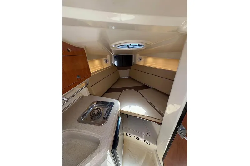 Slide: The Image of 2007 Triton 351 Express cabin interior with kitchenette and seating area. - 6