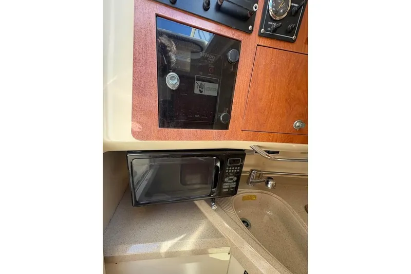 Slide: The Image of 2007 Triton 351 Express boat interior with microwave and sink. - 7