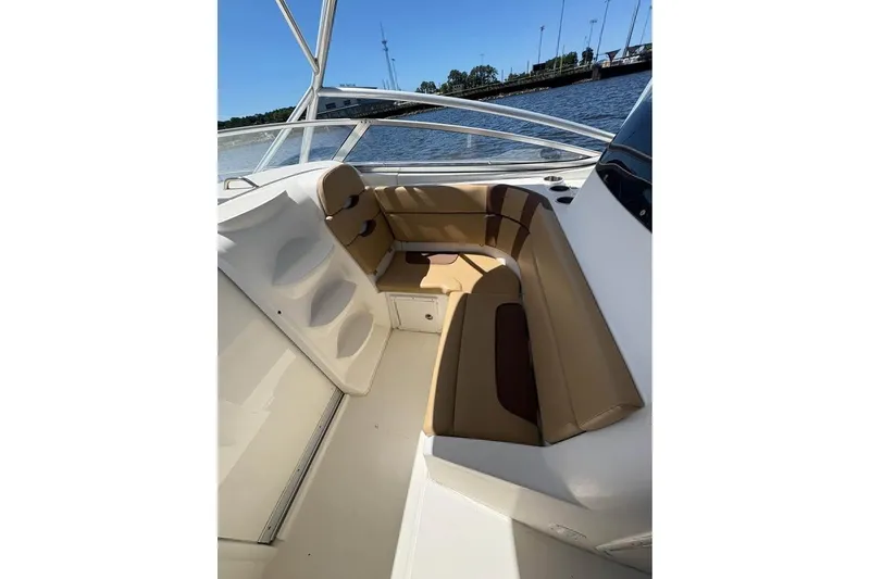 Slide: The Image of 2007 Triton 351 Express boat interior with tan seating, docked by the water. - 8