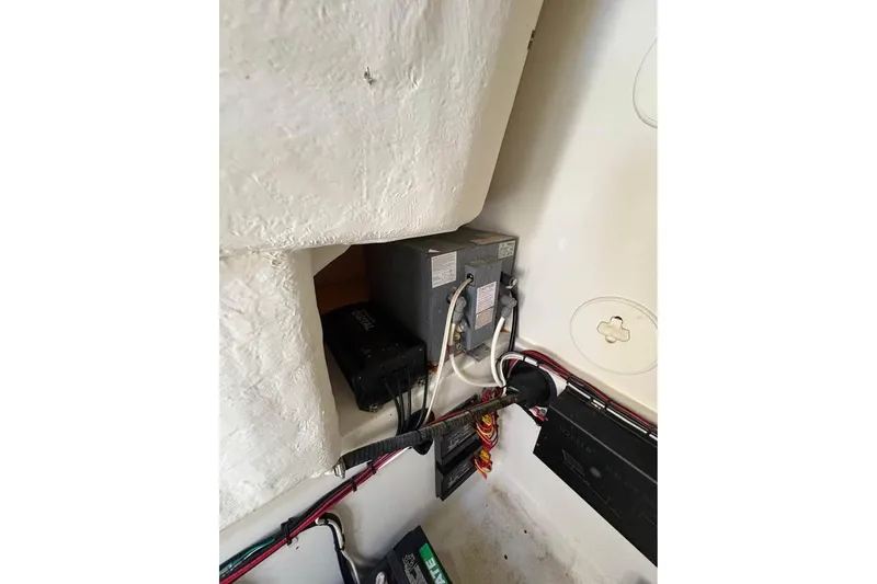 Slide: The Image of Electrical components inside a 2007 Triton 351 Express boat, featuring wiring and battery setup. - 9