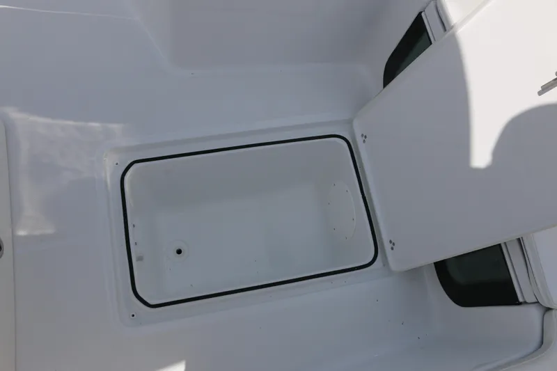 Slide: The Image of Open storage compartment on 2026 Wellcraft 202 Fisherman boat, showcasing interior space. - 10
