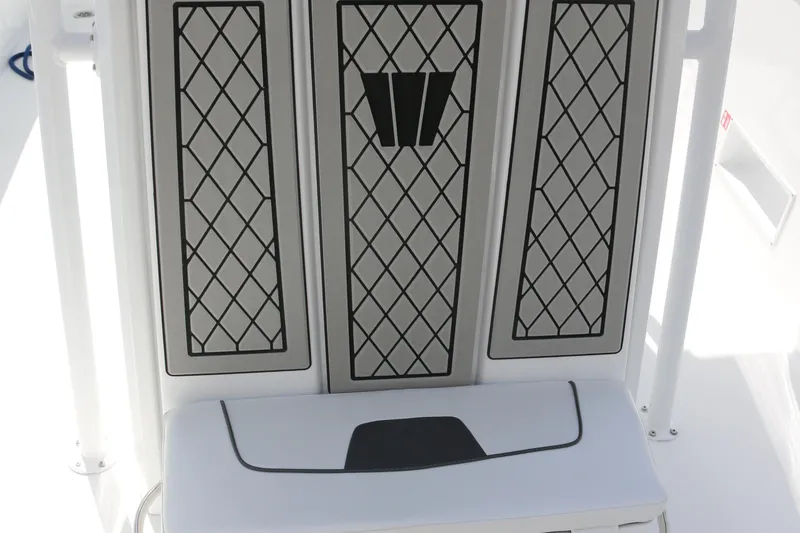 Slide: The Image of 2026 Wellcraft 202 Fisherman boat interior with diamond-patterned design. - 13