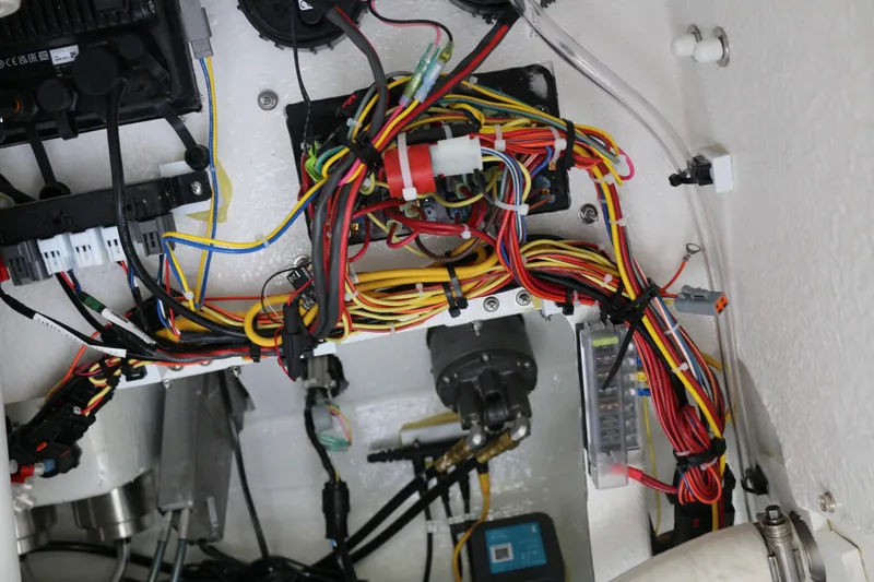 Slide: The Image of Electrical wiring system inside 2026 Wellcraft 202 Fisherman boat, showcasing complex cable arrangement. - 19