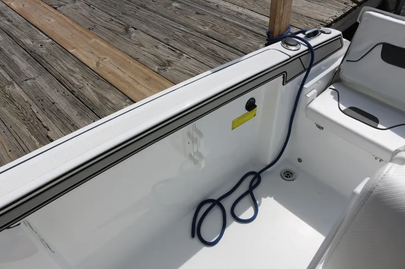 Slide: The Image of 2026 Wellcraft 202 Fisherman boat interior with blue rope and wooden dock. - 21