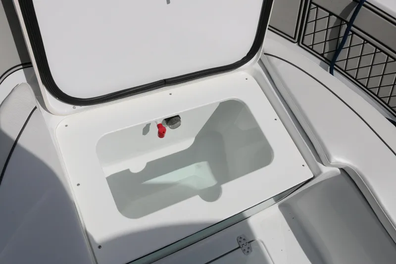 Slide: The Image of 2026 Wellcraft 202 Fisherman boat storage compartment, open lid, white interior. - 7