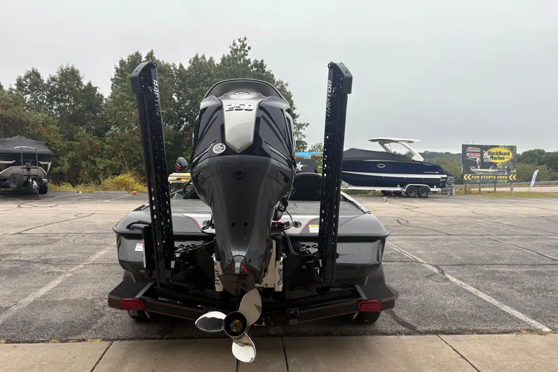 Slide: The Image of 2026 Skeeter ZXE21 boat with powerful outboard motor in a marina parking lot. - 3