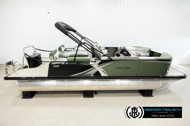 The Image of 2026 Avalon LSZ QLS pontoon boat with green and black design, displayed indoors. - 0