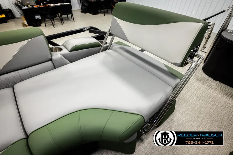 Slide: The Image of 2026 Avalon LSZ QLS boat interior with green and gray seating, cup holder, and adjustable backrest. - 21