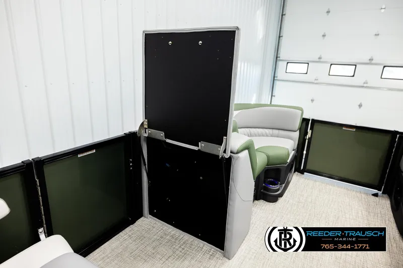 Slide: The Image of 2026 Avalon LSZ QLS pontoon interior with green and gray seating, Reeder-Trausch Marine branding. - 24