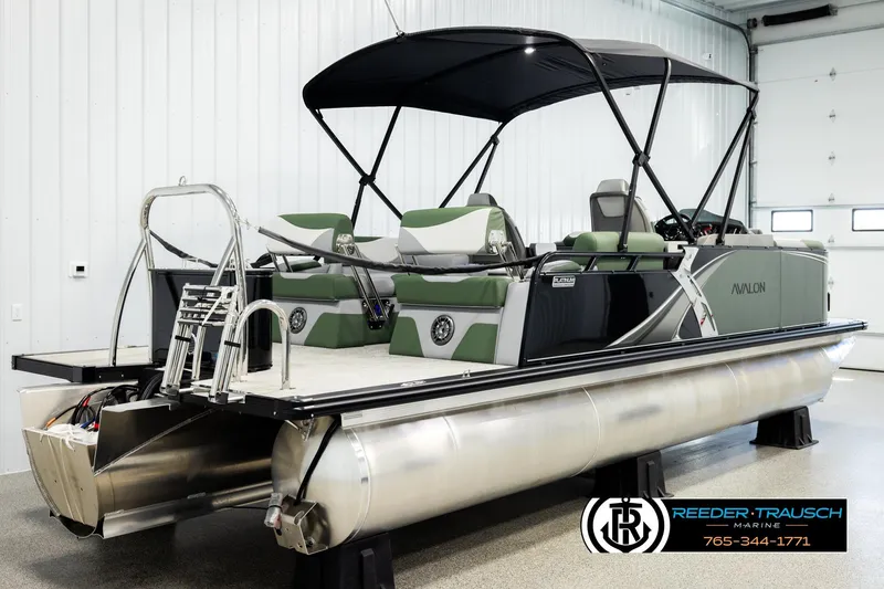 Slide: The Image of 2026 Avalon LSZ QLS pontoon boat with green seating and canopy in showroom. - 5
