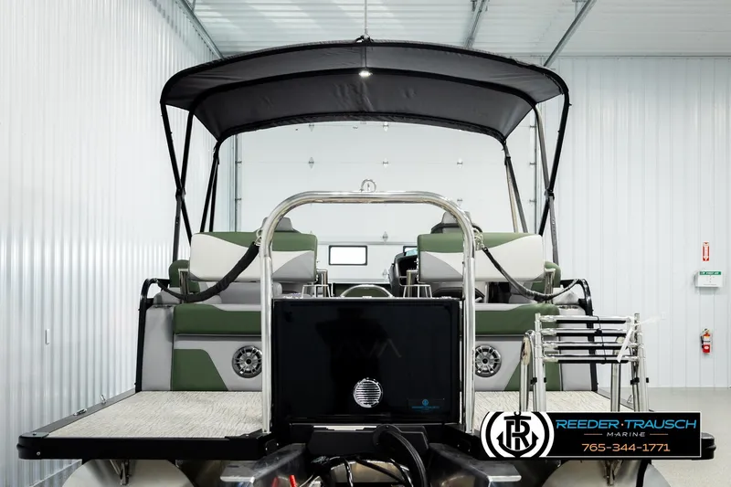 Slide: The Image of 2026 Avalon LSZ QLS pontoon boat in a showroom with canopy and seating. - 6