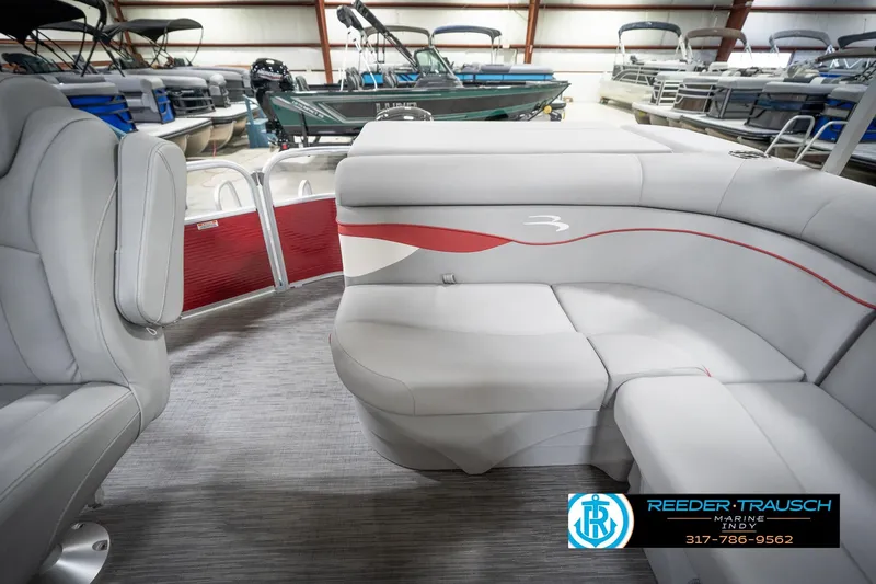 Slide: The Image of 2023 Bennington 20 SV pontoon boat interior with gray seating and red accents. - 18