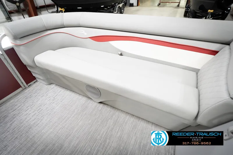 Slide: The Image of 2023 Bennington 20 SV boat interior with gray and red seating, showroom display. - 24