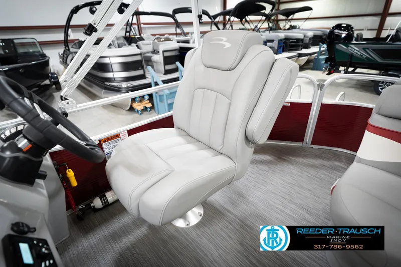 Slide: The Image of 2023 Bennington 20 SV boat interior with plush captain's chair and steering wheel. - 26