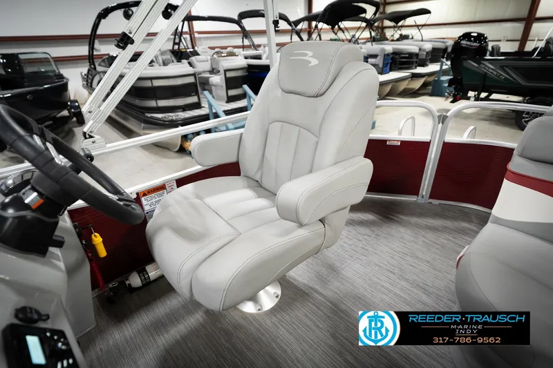 Slide: The Image of 2023 Bennington 20 SV boat interior with plush captain's chair and steering wheel. - 27
