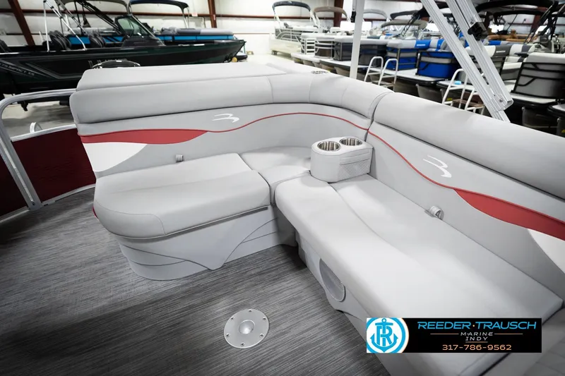 Slide: The Image of 2023 Bennington 20 SV pontoon boat interior with gray and red seating, cup holders. - 29