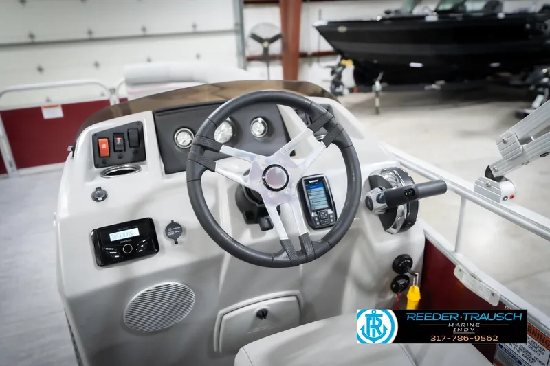 Slide: The Image of 2023 Bennington 20 SV boat dashboard with steering wheel and controls in showroom. - 35