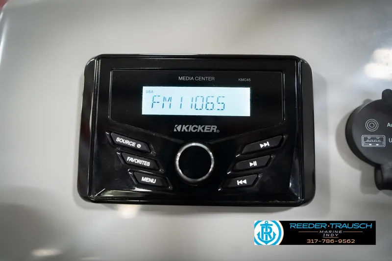 Slide: The Image of Kicker media center in 2023 Bennington 20 SV boat, displaying FM 106.5. - 37