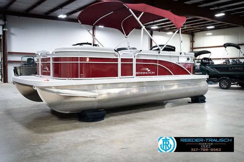 Slide: The Image of 2023 Bennington 20 SV pontoon boat with red canopy in showroom. - 4