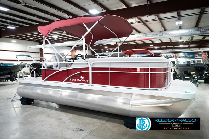 Slide: The Image of 2023 Bennington 20 SV pontoon boat with red canopy in showroom. - 6