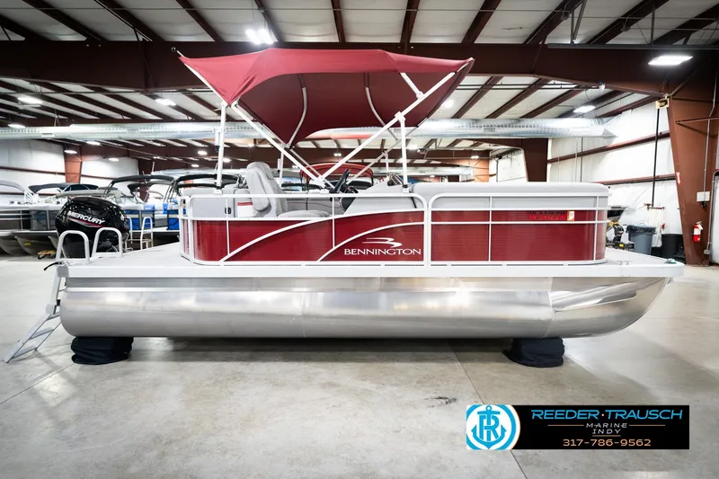 Slide: The Image of 2023 Bennington 20 SV pontoon boat with red canopy in showroom. - 7