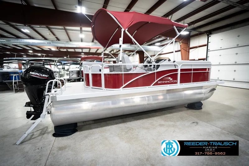 Slide: The Image of 2023 Bennington 20 SV pontoon boat with red canopy in showroom. - 8