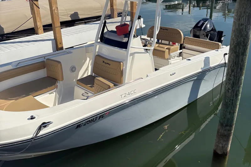 The Image of 2025 Trophy T22CC boat docked, featuring beige seating and sleek design. - 0