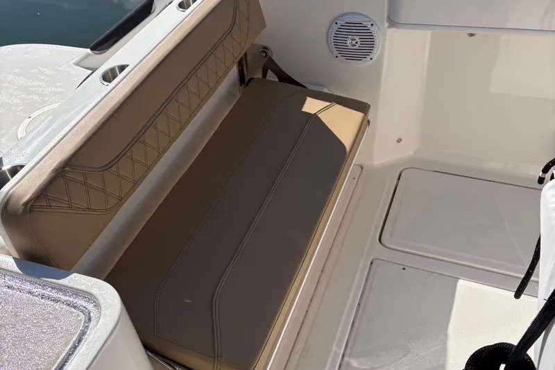 Slide: The Image of 2025 Trophy T22CC boat interior with cushioned seating and built-in speaker. - 6