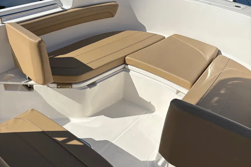 Slide: The Image of 2025 Trophy T22CC boat interior with tan cushioned seating arrangement. - 8