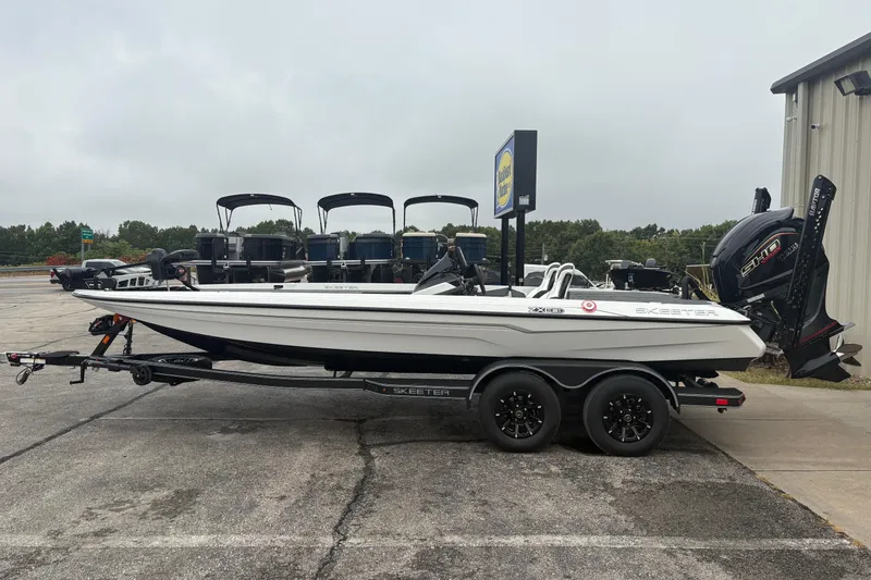 Slide: The Image of 2026 Skeeter ZXE21 boat on trailer, parked outdoors near dealership. - 3