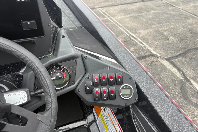 Slide: The Image of 2026 Skeeter ZXE21 boat dashboard with steering wheel and control panel. - 6