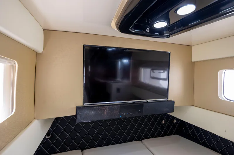 Slide: The Image of 2019 Scout 420 LXF boat on calm water under a blue sky. - 11