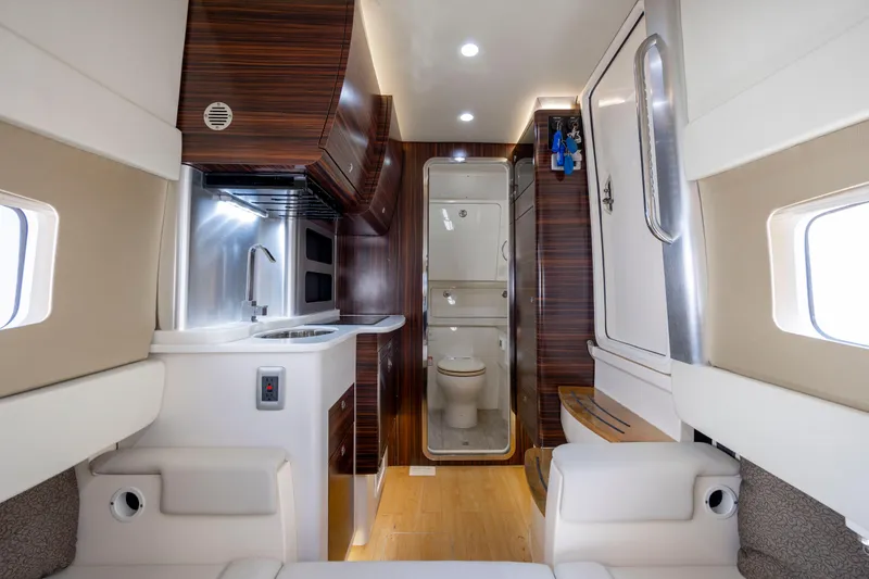 Slide: The Image of 2019 Scout 420 LXF boat with quad Mercury engines, spacious deck, and comfortable seating. - 12