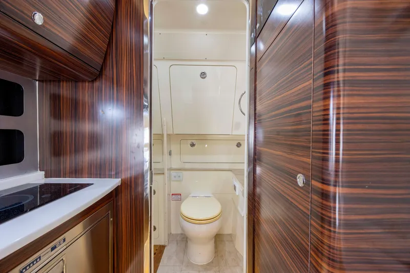 Slide: The Image of 2019 Scout 420 LXF boat helm with advanced navigation system and waterfront view. - 16