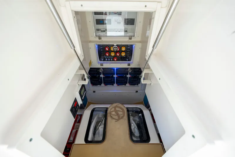 Slide: The Image of 2019 Scout 420 LXF boat on calm water under a blue sky with clouds. - 19