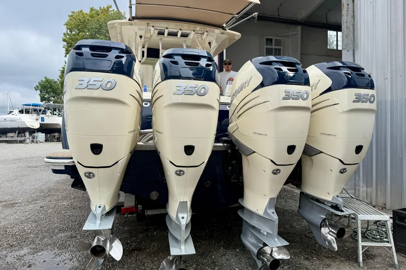 Slide: The Image of 2019 Scout 420 LXF boat cruising on calm water under a blue sky. - 2