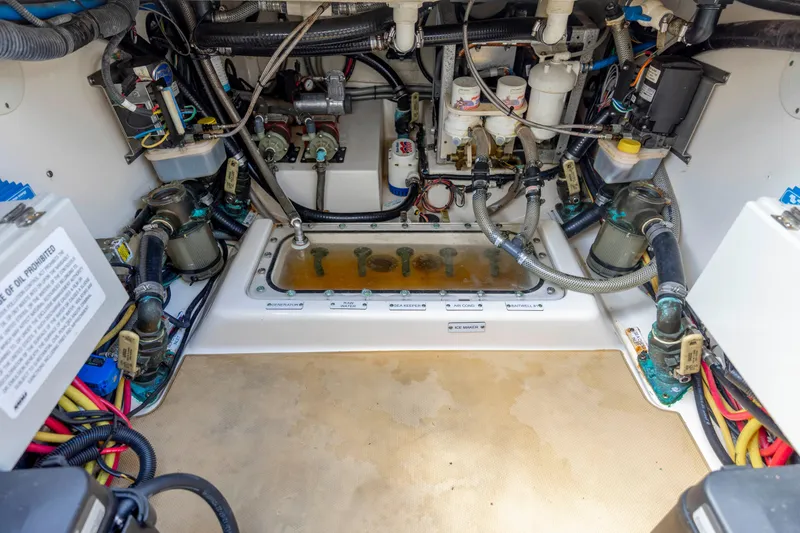 Slide: The Image of 2019 Scout 420 LXF boat on calm water under a blue sky with clouds. - 21